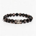 Midnight Shield Silver Sheen Obsidian bracelet with 10mm black beads and a silver-tone pavé centerpiece.
