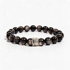 Midnight Shield Silver Sheen Obsidian bracelet with 10mm black beads and a silver-tone pavé centerpiece.