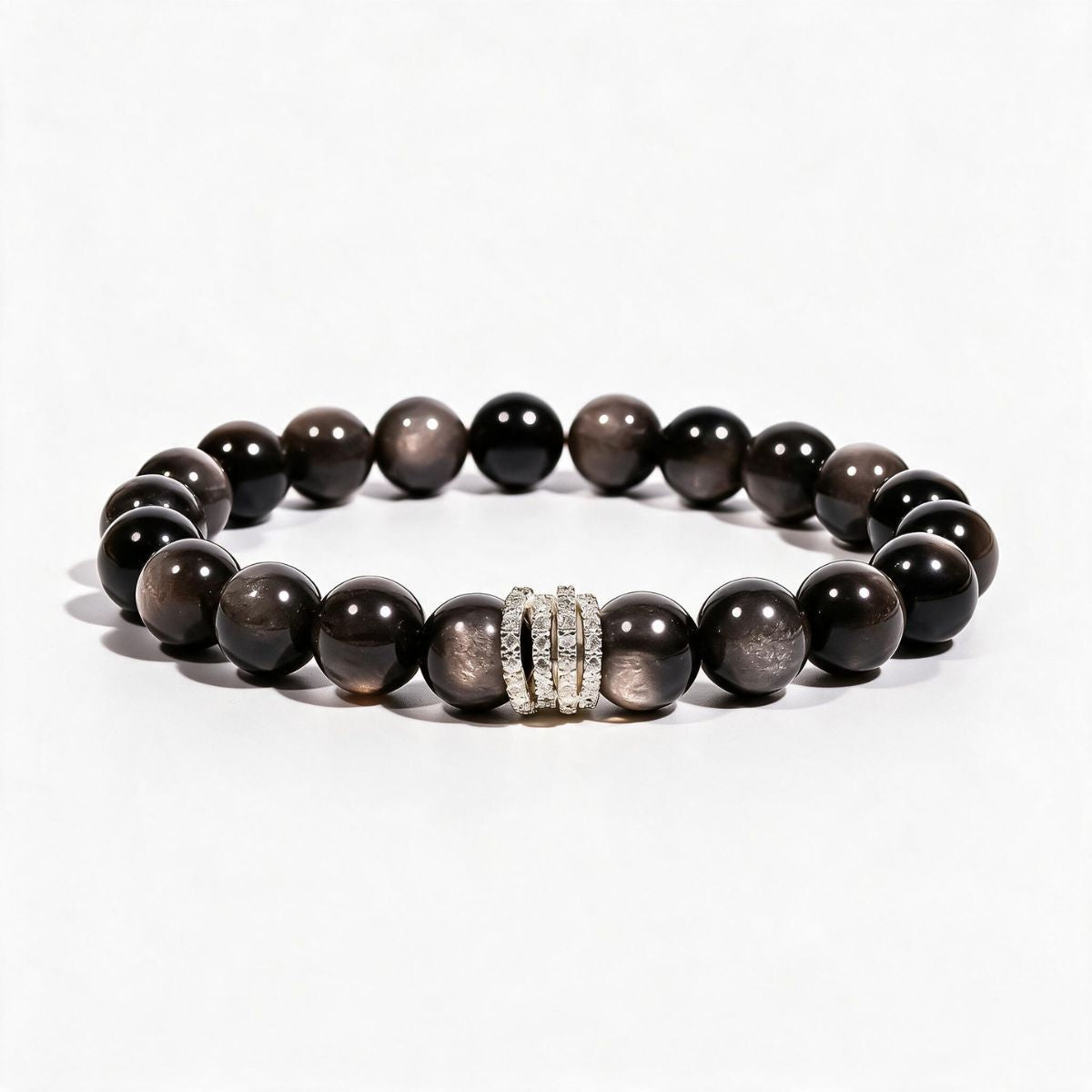 Midnight Shield Silver Sheen Obsidian bracelet with 10mm black beads and a silver-tone pavé centerpiece.