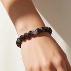 Woman wearing Midnight Shield Silver Sheen Obsidian Beaded Bracelet with deep black 10mm beads