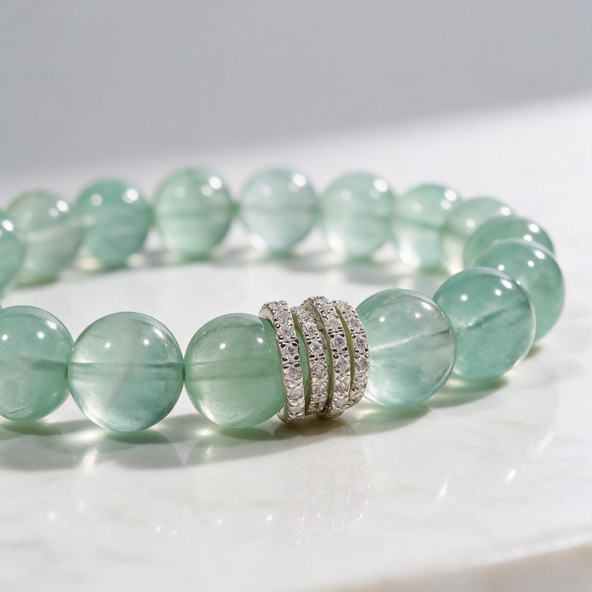 Close-up of natural Green Fluorite beads showing soft mint-green color and natural translucency