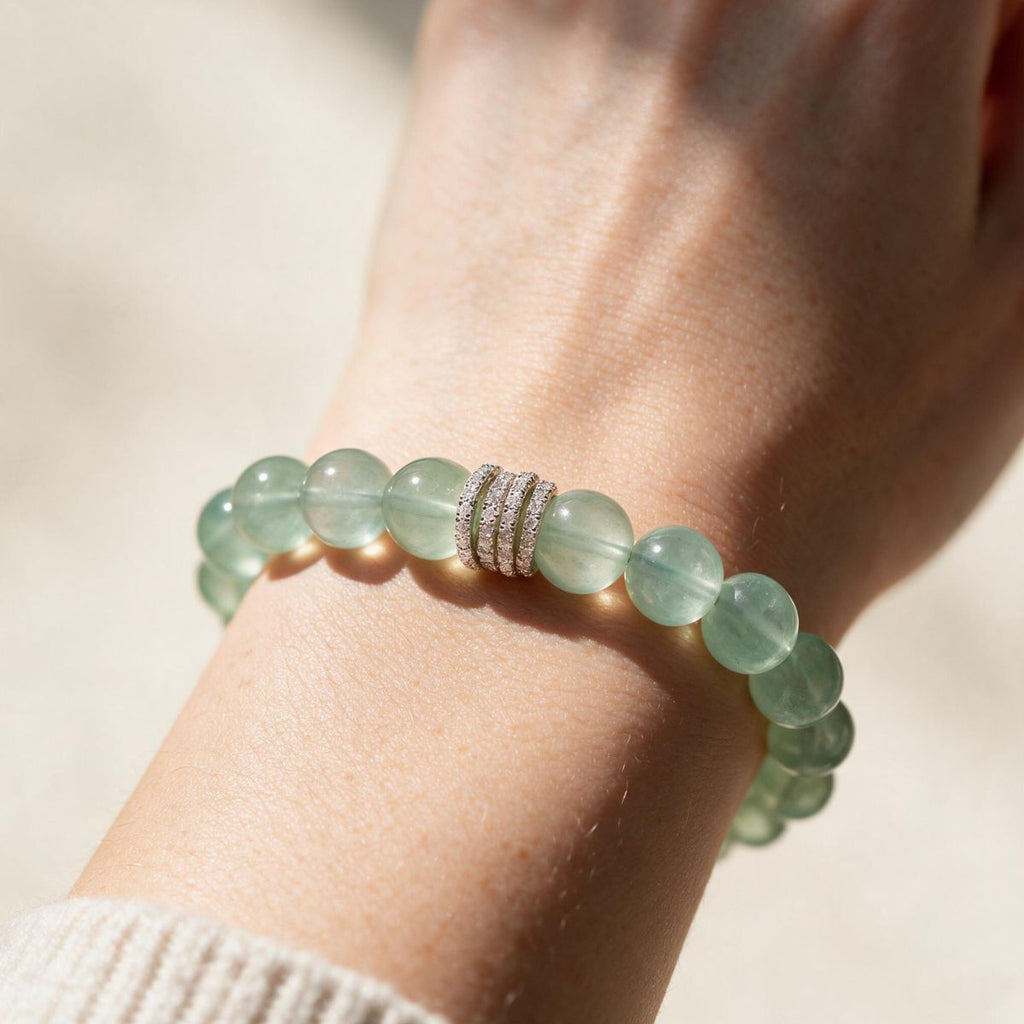 Mint green Fluorite bracelet styled on the wrist with a soft neutral knit