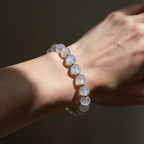 Mystic Moonstone Bracelet worn on a woman’s wrist in sunlight, showing its delicate 8mm profile