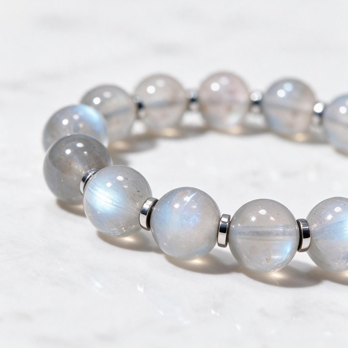 Close-up of natural 8mm moonstone beads showing milky translucency and a subtle cool-blue flash