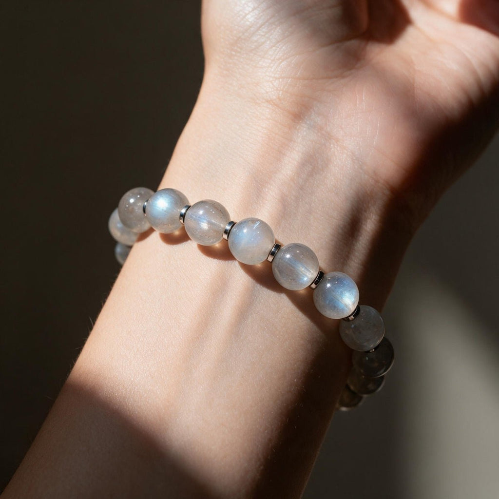 Lightweight natural 8mm moonstone stretch bracelet worn on a woman’s wrist in directional sunlight