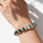 Natural Green Phantom Quartz crystal bracelet worn on the wrist with layered forest-like inclusions