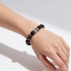 Natural Silver Sheen Obsidian crystal bracelet worn on the wrist with a polished black and silver look