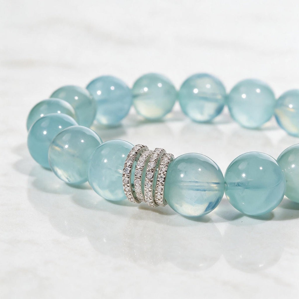 Detailed view of the Ocean Calm aquamarine bracelet on a pale stone surface