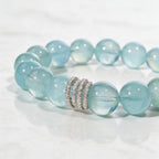 Detailed view of the Ocean Calm aquamarine bracelet on a pale stone surface