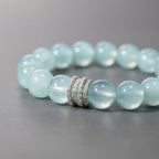 Close-up of natural aquamarine beaded bracelet with 12mm blue beads and silver centerpiece detail