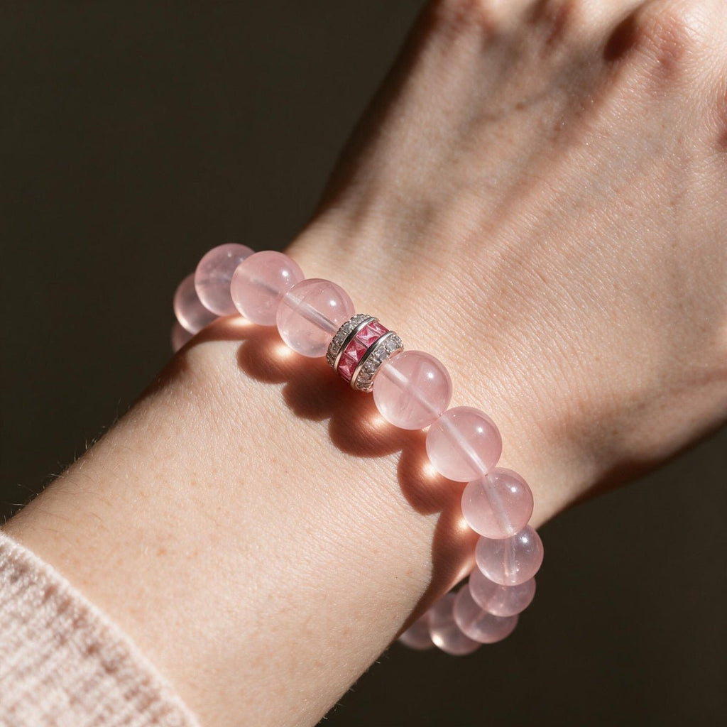Blush-pink Rose Quartz bracelet worn on the wrist with its sterling silver centerpiece visible