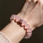 Blush-pink Rose Quartz bracelet worn on the wrist with its sterling silver centerpiece visible