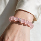 Pure Heart Rose Quartz Bracelet styled with a white sleeve for polished everyday wear