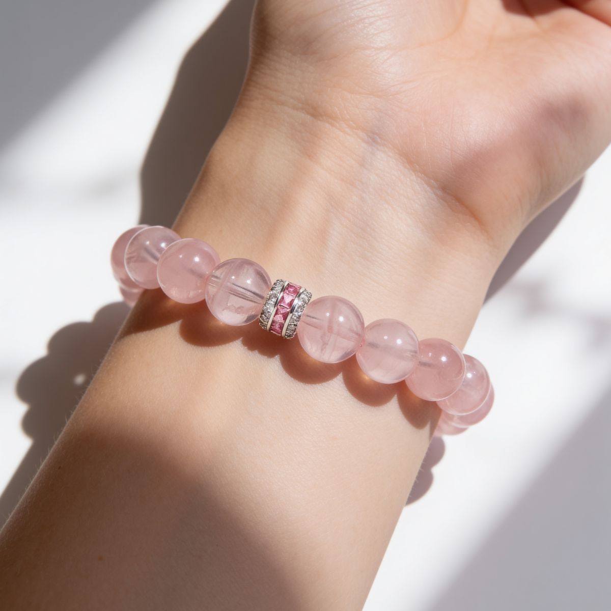 Pure Heart natural Madagascar Rose Quartz bracelet with 12mm blush-pink beads and a sterling silver centerpiece.