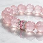 Pure Heart Rose Quartz Bracelet on a reflective white surface showing translucent pink beads