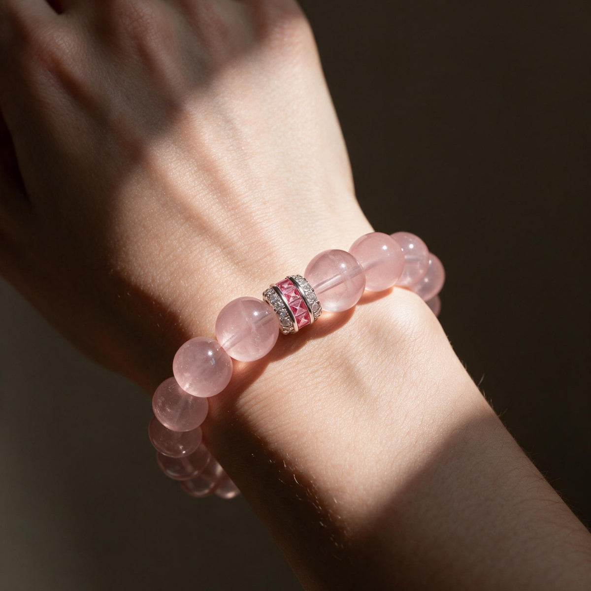 Pure Heart Madagascar Rose Quartz Bracelet worn on the wrist in warm natural light