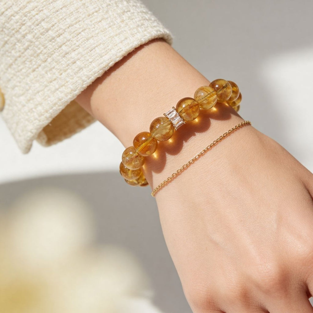 Natural citrine bracelet for women worn on wrist with soft cream sweater