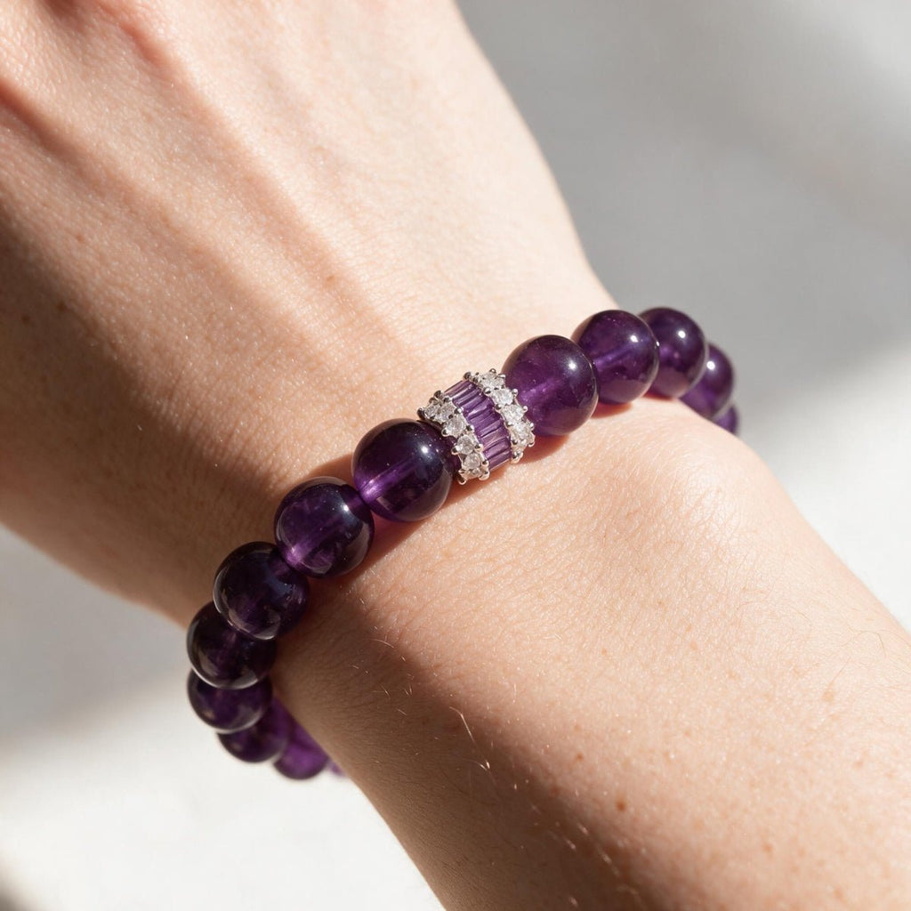 Woman wearing the Royal Amethyst Elegance Bracelet in soft warm light.