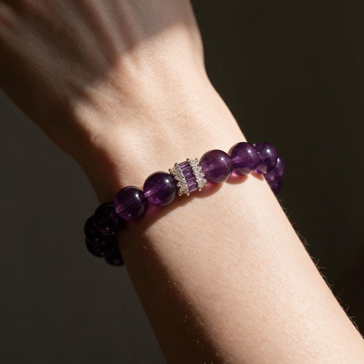 Royal Amethyst Elegance Bracelet worn on a woman’s wrist in warm sunlight.