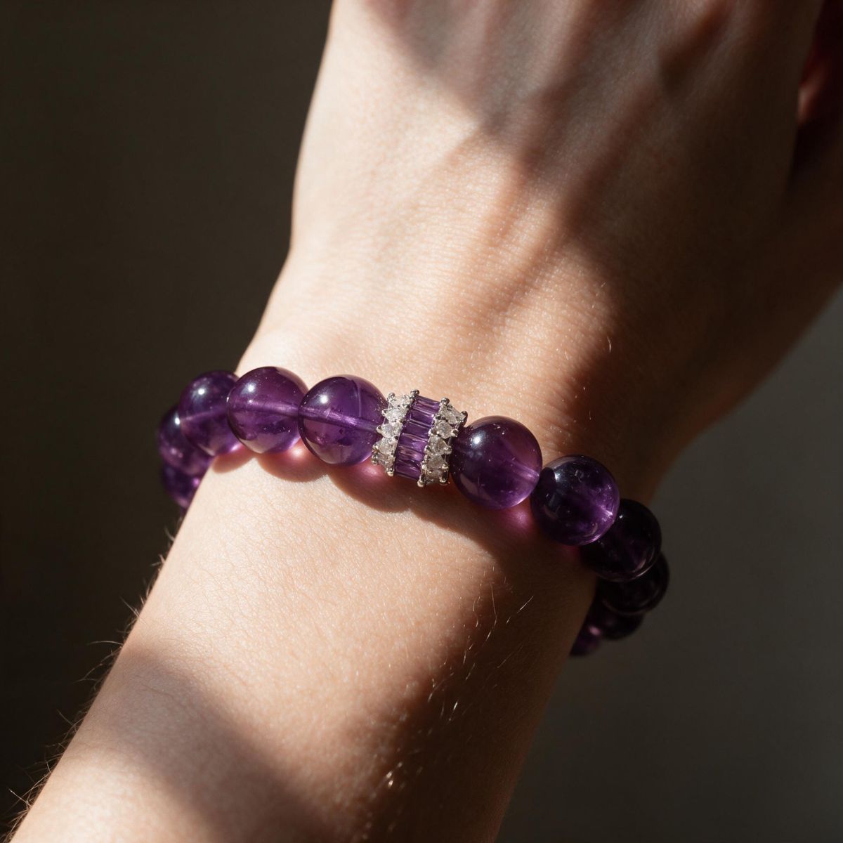 Close wrist view of the Royal Amethyst Elegance Bracelet in directional sunlight.