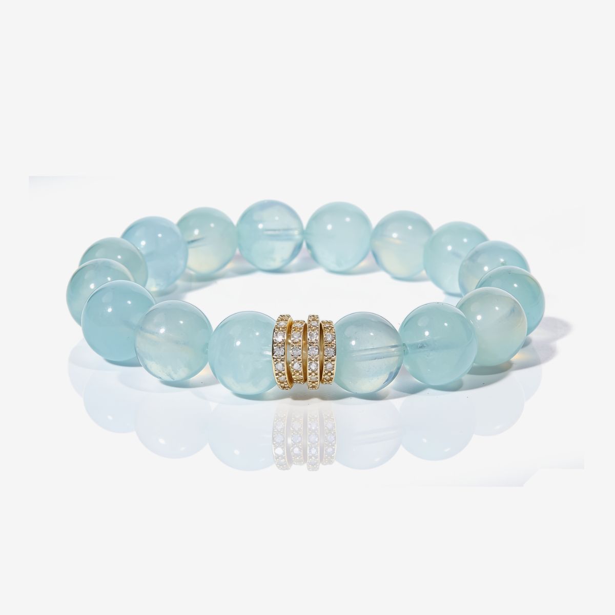 Natural Brazilian aquamarine bracelet with 12mm beads and Gold Pavé Stack centerpiece on a white background.