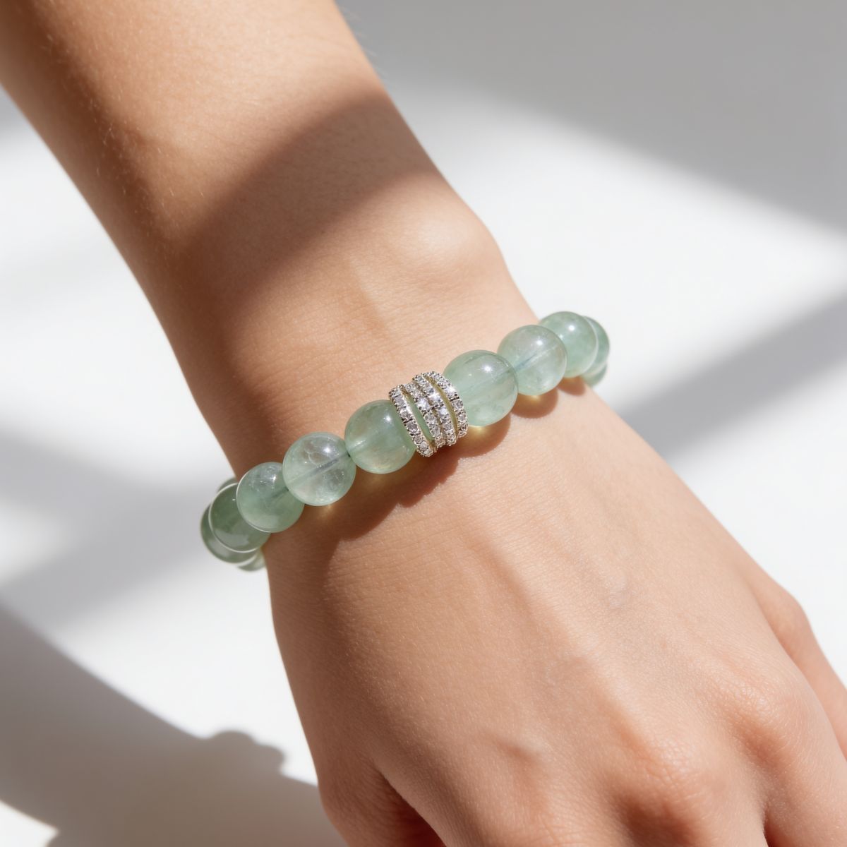 Close-up of South African Green Fluorite bracelet worn on the wrist with silver-tone cubic zirconia centerpiece