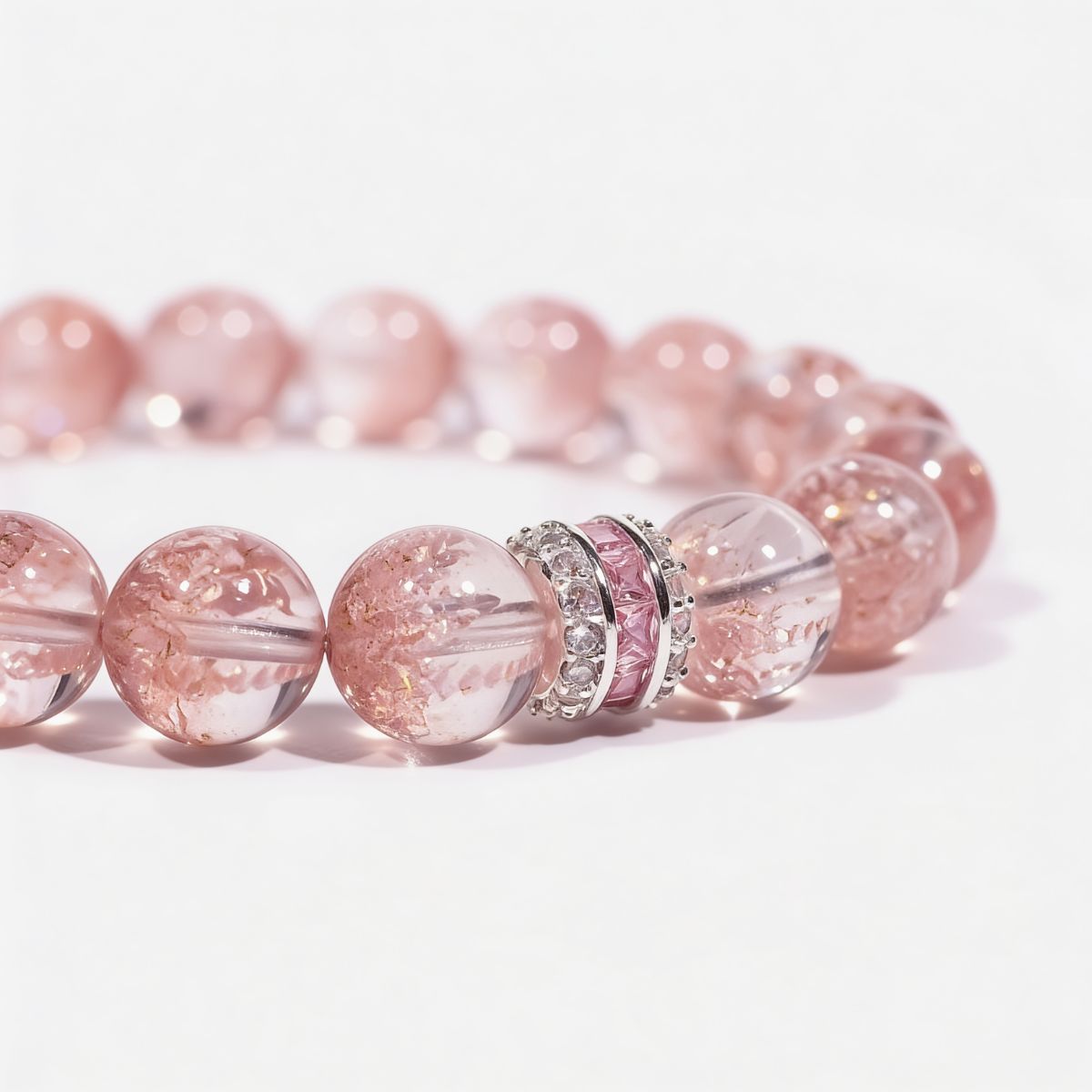 Close-up of Strawberry Quartz beaded bracelet with pink baguette centerpiece and clear light-catching accents