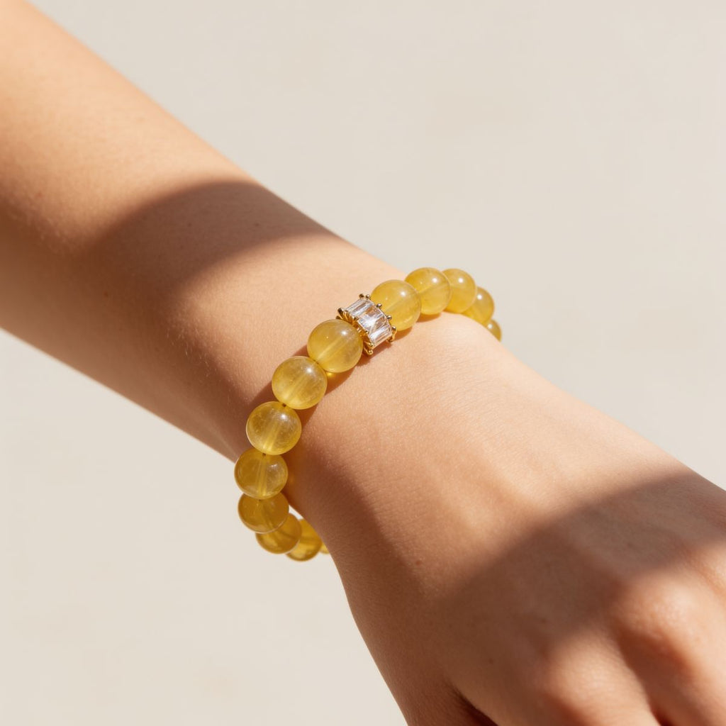 Woman wearing a South African Yellow Fluorite bracelet with warm golden-yellow beads