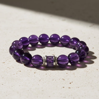 natural amethyst gemstone bracelet displayed on surface, purple birthstone healing jewelry