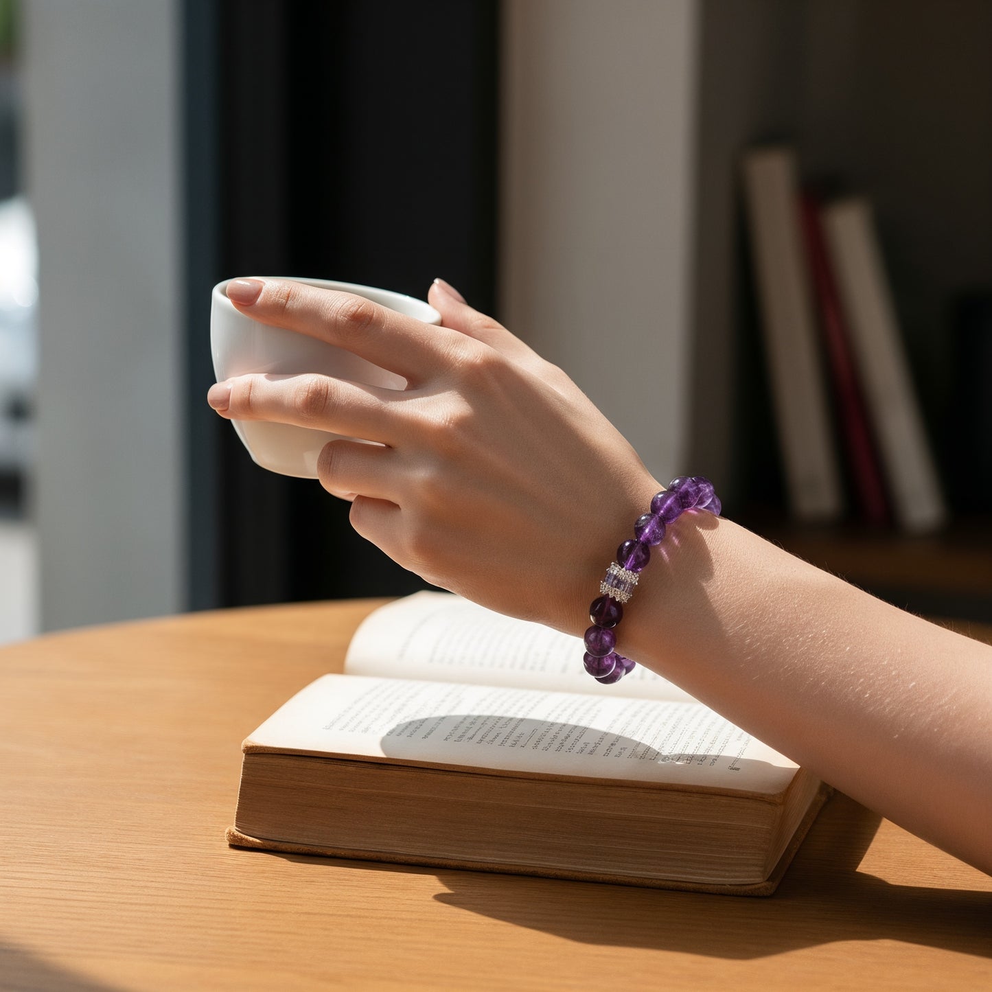 amethyst healing crystal bracelet worn while reading, calming purple crystal bracelet for focus