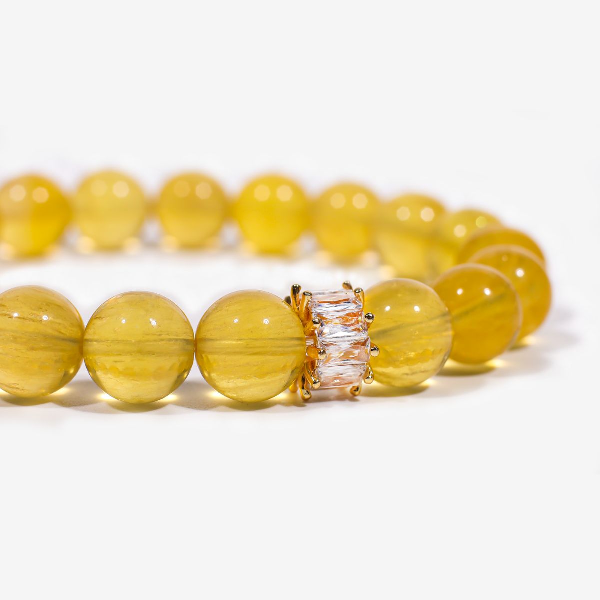 Close-up of Yellow Fluorite beaded bracelet with translucent 10mm beads and clear baguette centerpiece