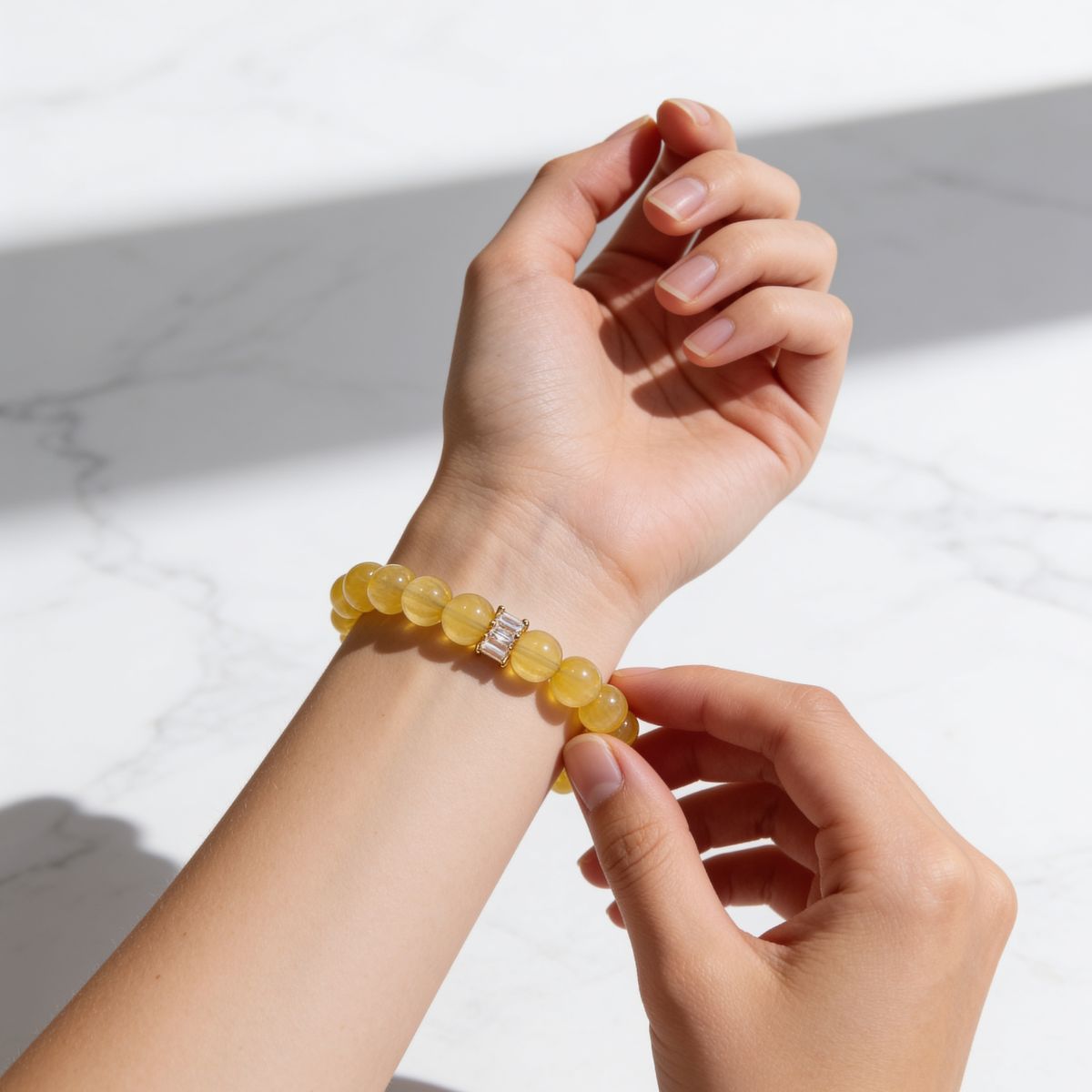 Natural Yellow Fluorite crystal bracelet worn on the wrist with golden-yellow translucent beads