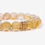 Close-up of Yellow Quartz beaded bracelet with icy golden beads and gold-tone pavé ring centerpiece